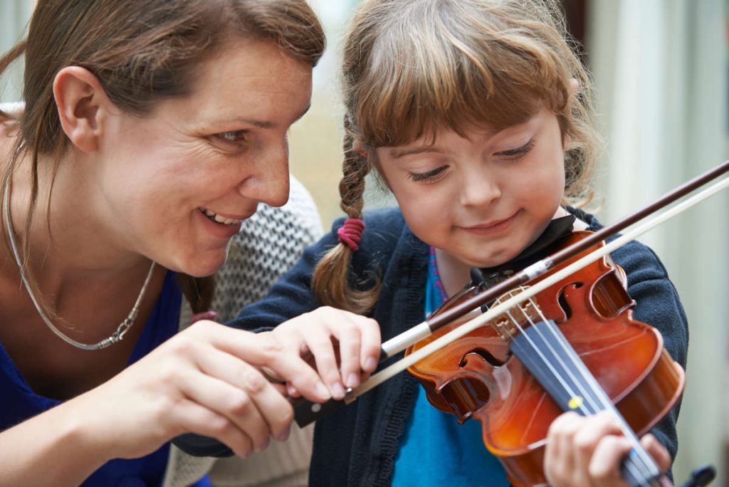 young violinist with teacher